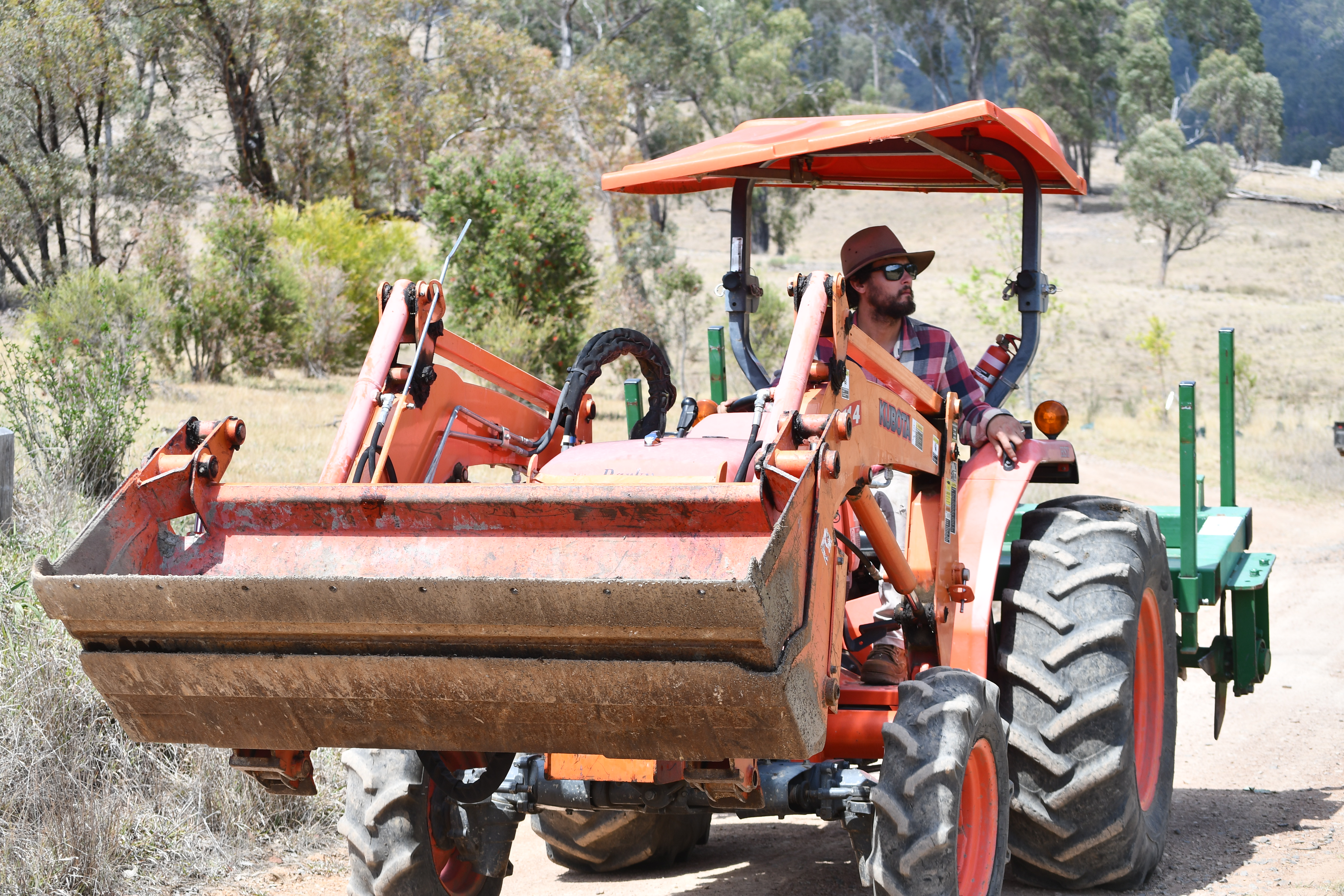 Brayden on the orange Kubota tractor at Springcart Farm, Northern Tablelands NSW